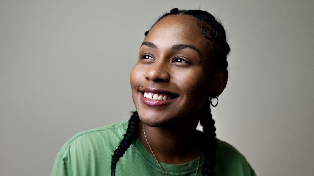 young smiling woman with braids in her hair